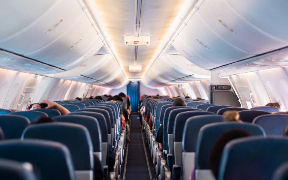 Ansicht eines Flugzeuges von innen mit leeren und schon besetzen Pl&auml;tzen